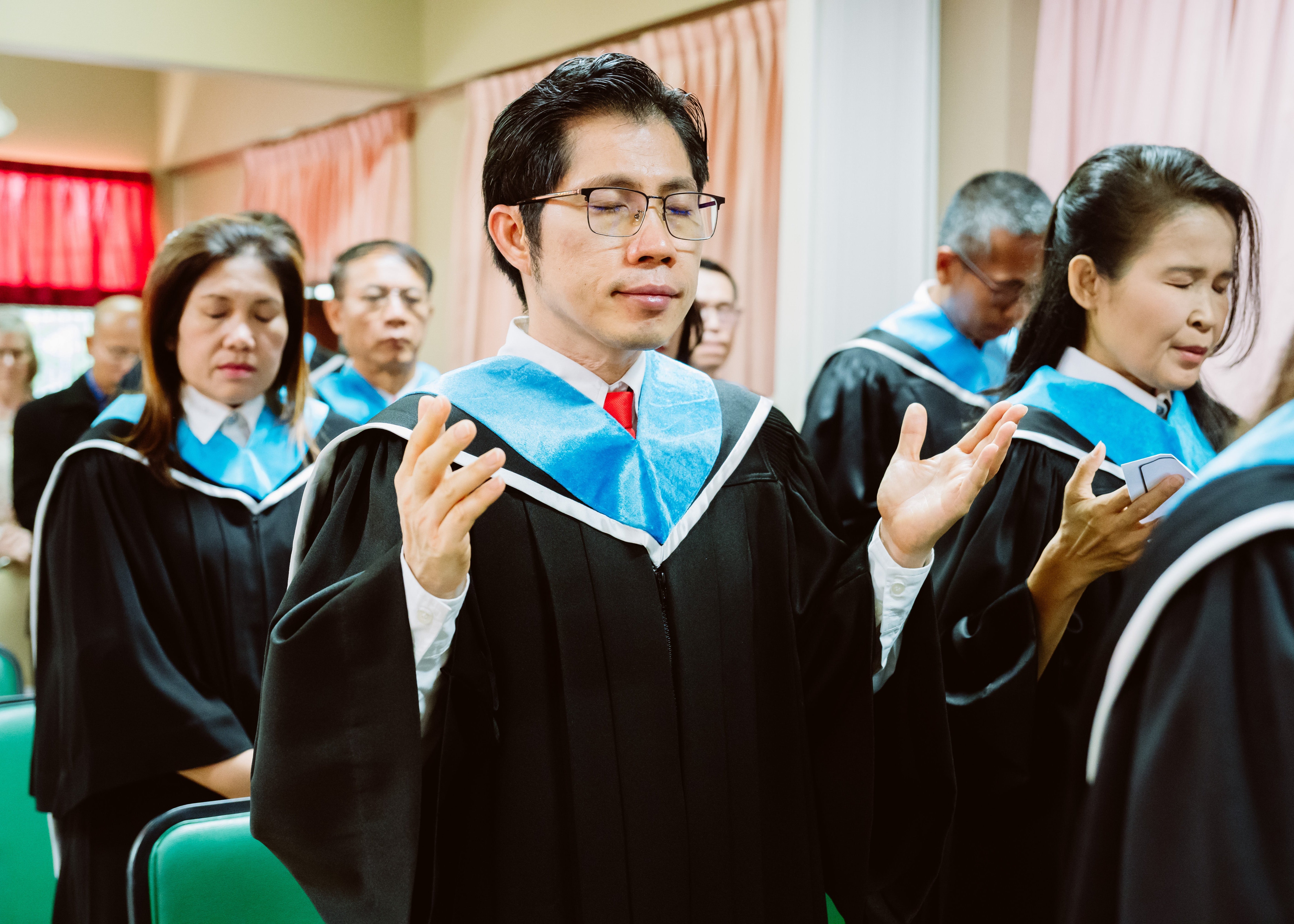 Graduates in caps and gowns at a graduation ceremony.