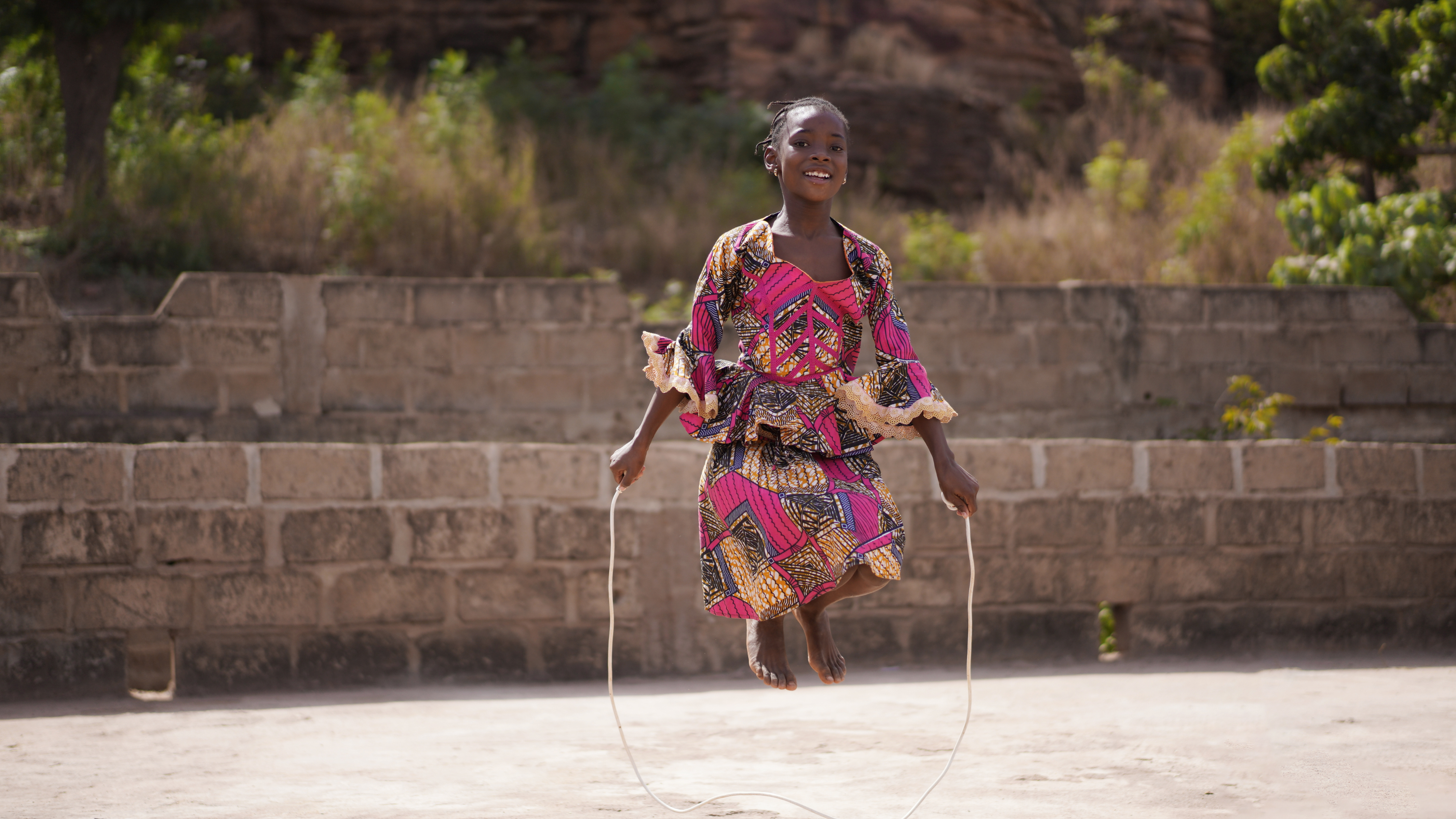 Young girl jumping with rope